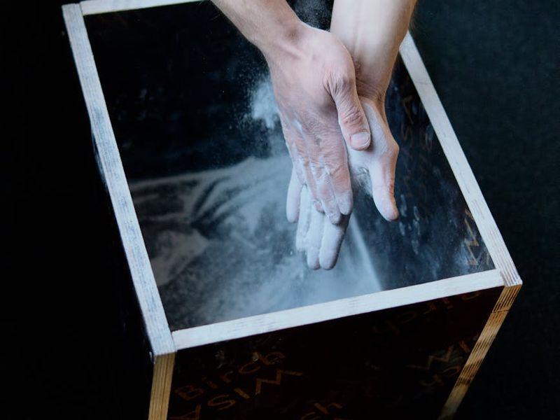 Close-up of gym equipment and a man hands preparing for exercise
