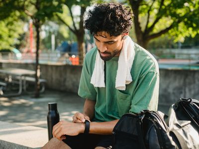 White sports towel and a water bottle on a bench